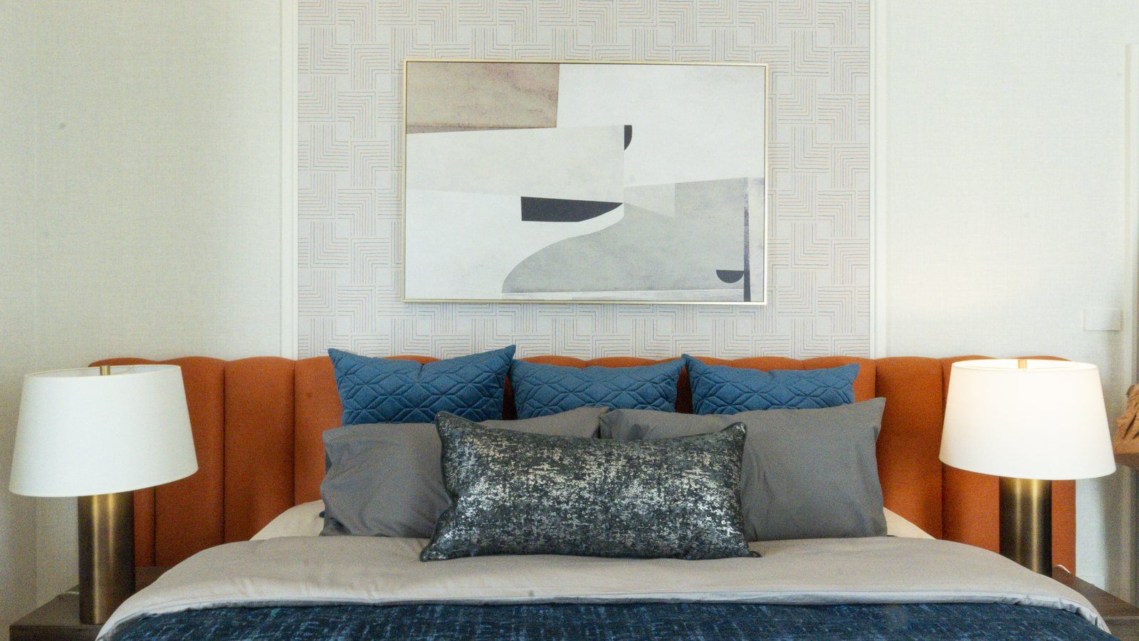 Bedroom with a blue upholstered headboard